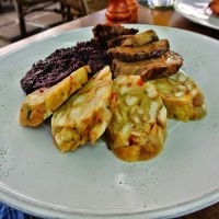 Roasted pork shoulder with steamed cabbage served with bread dumplings @ Slang Pub